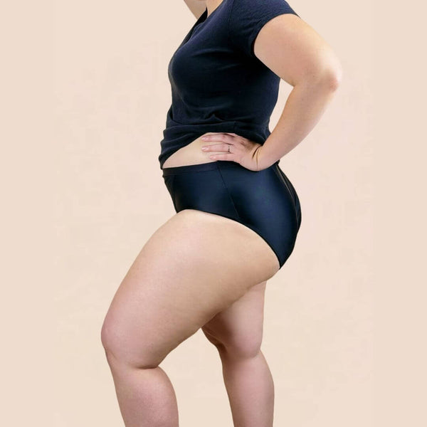 Model wears the prolapse support underwear from Hem Support Wear. Side view of model wearing Curvy 1x