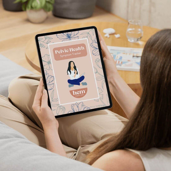 Woman using Hem’s pelvic health symptom tracker on a tablet—supporting POP awareness and daily symptom tracking.